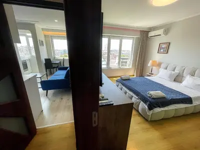 a bedroom with a bed and a living room at Amazing view central 1 bedroom apartment in Pazardzhik