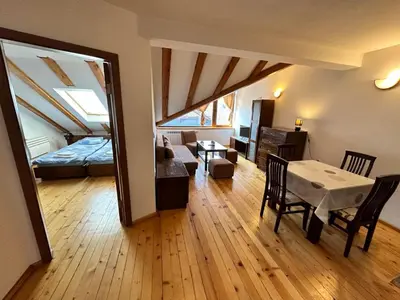 a living room with a bed and a dining table at Snow Legend private apartments in Bansko