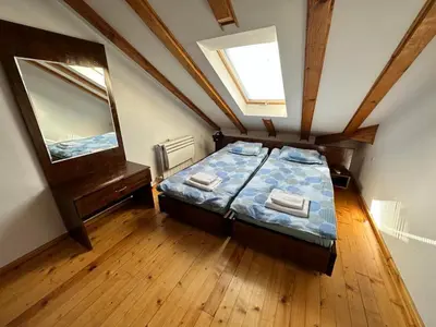 a bedroom with a bed and a large mirror at Snow Legend private apartments in Bansko