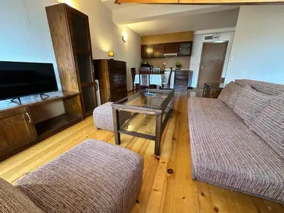 a living room with two couches and a table at Snow Legend private apartments in Bansko