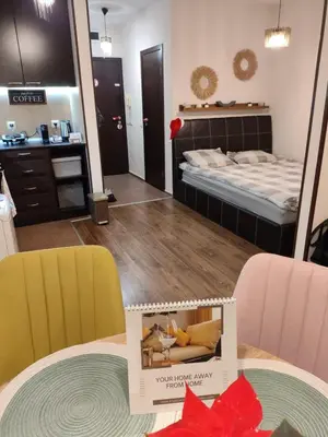 a room with a table with two chairs and a mirror at Studio Stankovic Royal Towers 326 in Bansko