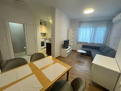 a small living room with a table and a couch at Top Center 2-BR Apartment with lovely Outdoor Area in Plovdiv