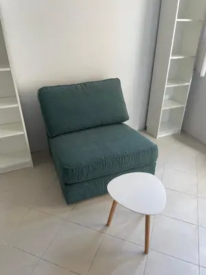 a green couch and a stool in a room at Top Center 2-BR Apartment with lovely Outdoor Area in Plovdiv