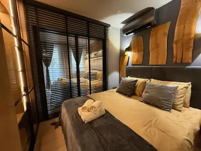 a bedroom with a bed with two towels on it at Ski Bansko Design Apartments in Bansko