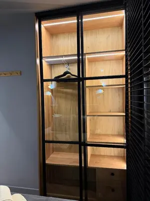 a closet with wooden shelves in a room at Ski Bansko Design Apartments in Bansko