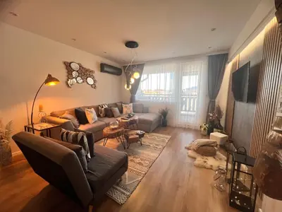 a living room with a couch and a table at Ski Bansko Design Apartments in Bansko
