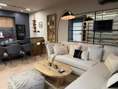 a living room with a white couch and a table at Ski Bansko Design Apartments in Bansko