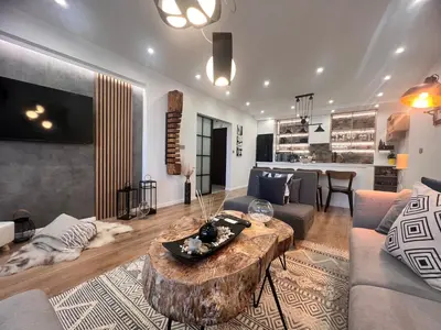 a living room with a couch and a coffee table at Ski Bansko Design Apartments in Bansko
