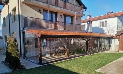 a house with a large deck with a balcony at Къща за гости - Вила Сидона in Banya