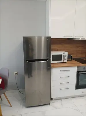 a stainless steel refrigerator in a kitchen with a microwave at One Bedroom Apartment 37- Trakia 54 А in Plovdiv