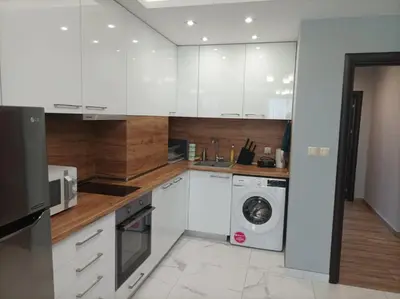 a kitchen with white cabinets and a washer and dryer at One Bedroom Apartment 37- Trakia 54 А in Plovdiv