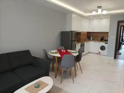 a living room with a couch and a table and chairs at One Bedroom Apartment 37- Trakia 54 А in Plovdiv