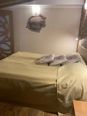 a bedroom with a bed with two pillows on it at Boutique & artistic 3 bedroom apartment. in Pamporovo