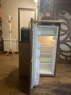 an empty refrigerator with its door open in a room at Boutique & artistic 3 bedroom apartment. in Pamporovo