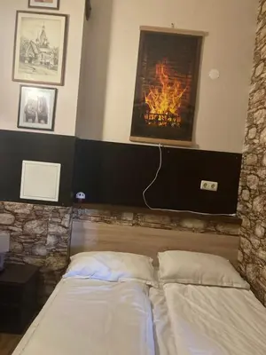 two beds in a room with a fireplace at Boutique & artistic 3 bedroom apartment. in Pamporovo