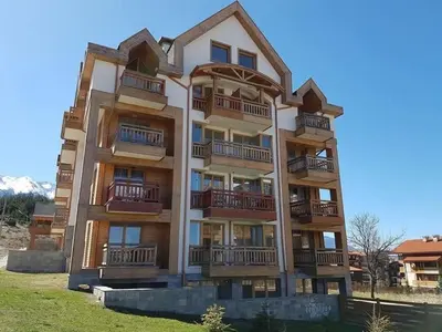 a tall building with balconies on the side of it at Secluded Mountain Cozy Studio with Fireplace in Bansko