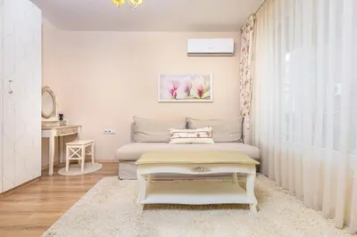 a small bedroom with a bed and a table at Bright & Cozy 1BD Flat with a Terrace and Parking by Flat Mаnager in Plovdiv