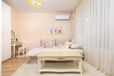 a small bedroom with a bed and a table at Bright & Cozy 1BD Flat with a Terrace and Parking by Flat Mаnager in Plovdiv