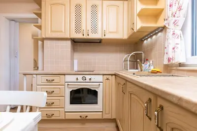 a kitchen with wooden cabinets and a sink at Bright & Cozy 1BD Flat with a Terrace and Parking by Flat Mаnager in Plovdiv