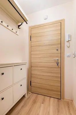 a closet with a wooden door in a room at Bright & Cozy 1BD Flat with a Terrace and Parking by Flat Mаnager in Plovdiv