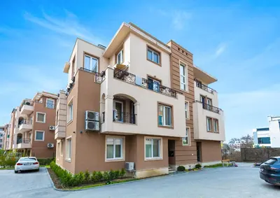 a building with a car parked in a parking lot at Bright & Cozy 1BD Flat with a Terrace and Parking by Flat Mаnager in Plovdiv