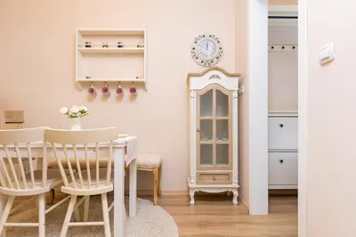 a dining room with a table and chairs and a clock at Bright & Cozy 1BD Flat with a Terrace and Parking by Flat Mаnager in Plovdiv