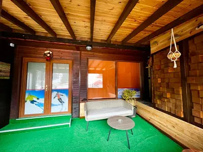 a room with a couch and a table and a window at Roots Apartment 2 in Borovets