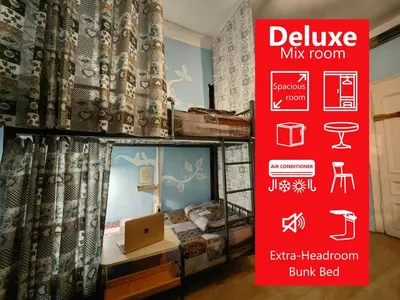 a sign for a bedroom with a bed and a laptop at 