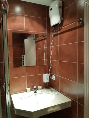 a bathroom with a sink and a mirror at Gondola lift apartment in Bansko