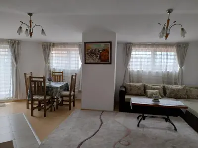 a living room with a couch and a table at Gondola lift apartment in Bansko