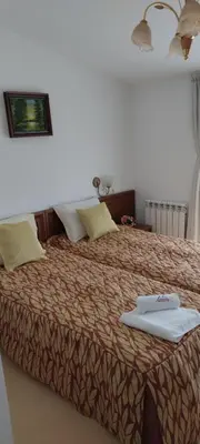 a bedroom with a large bed with two towels on it at Gondola lift apartment in Bansko