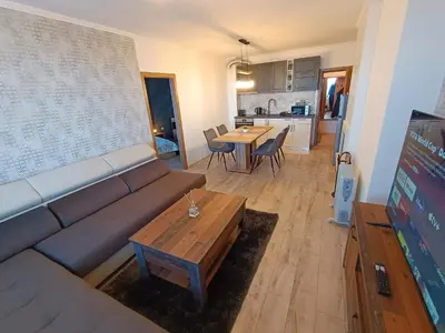 a living room with a couch and a table at Viva 4 Apartment ski to the door complex Grand Monastery Pamporovo in Pamporovo