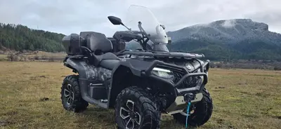 a black four wheeler parked in a field at Апартамент Bella Casa in Beli Iskar