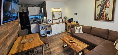 a living room with a couch and a table at Апартамент Bella Casa in Beli Iskar