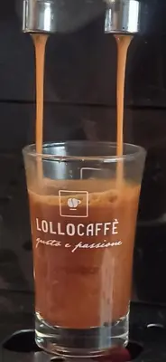 a glass of coffee with two spoons in it at Апартамент Bella Casa in Beli Iskar