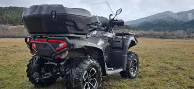a atv parked in a field with mountains in the background at Апартамент Bella Casa in Beli Iskar