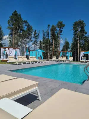 a pool with chaise lounge chairs at 103 View Park Hotel in Panichishte
