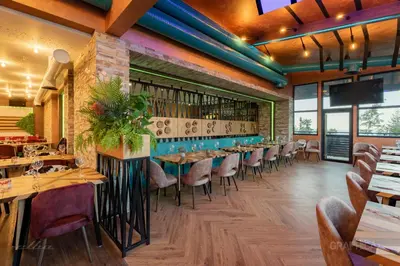 a restaurant with tables and chairs in a room at 103 View Park Hotel in Panichishte