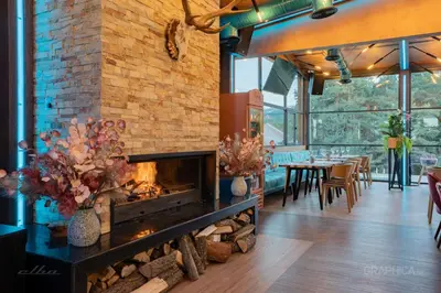 a fireplace in a room with a brick wall at 103 View Park Hotel in Panichishte