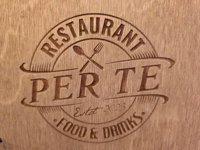 a wooden sign for a restaurant with a fork and knife at Апартамент Edelweiss in Beli Iskar