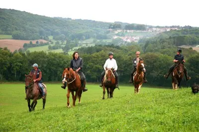 a group of people riding horses in a field at Апартамент Edelweiss in Beli Iskar