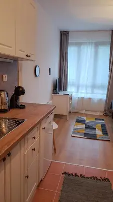 a kitchen with white cabinets and a counter top at Semiramida Garden Apartment 12 in Borovets