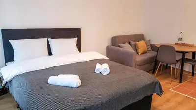 a bedroom with a bed with a pair of shoes on it at Semiramida Garden Apartment 12 in Borovets