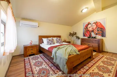 a bedroom with a bed and a painting on the wall at MOMA - Charming home in the heart of Bansko Ancient Center in Bansko