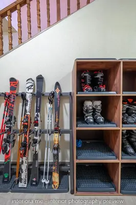 a bunch of skis and snowboards are on shelves at MOMA - Charming home in the heart of Bansko Ancient Center in Bansko