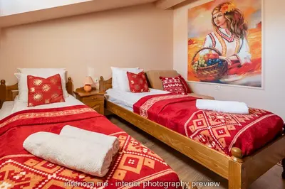 a bedroom with two beds and a painting on the wall at MOMA - Charming home in the heart of Bansko Ancient Center in Bansko