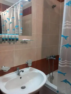 a bathroom with a sink and a shower at Апартамент в хотел Стената, Пампорово in Smolyan