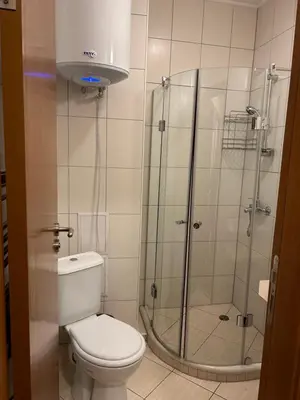a bathroom with a toilet and a glass shower at Charming apartmnet near Gondola and Bar street in Bansko