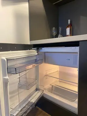 an empty refrigerator with its door open in a kitchen at Studio Nr 6 in Bansko