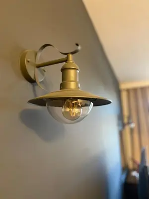 a gold light fixture on the wall of a room at Studio Nr 6 in Bansko